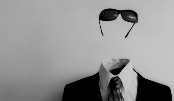 invisible man wearing glasses and a suit but has no actual head